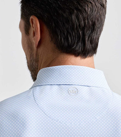 Grant Performance Mesh Polo in light blue with subtle geometric pattern and breathable stretch fabric