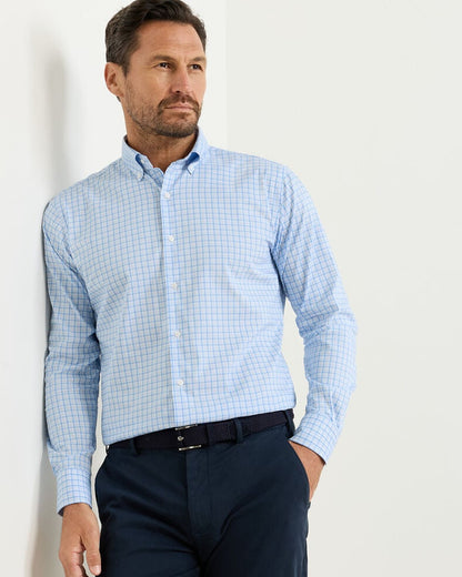 Man wearing Calvin Crown Lite Cotton-Stretch Sport Shirt in blue checkered, moisture-wicking fabric