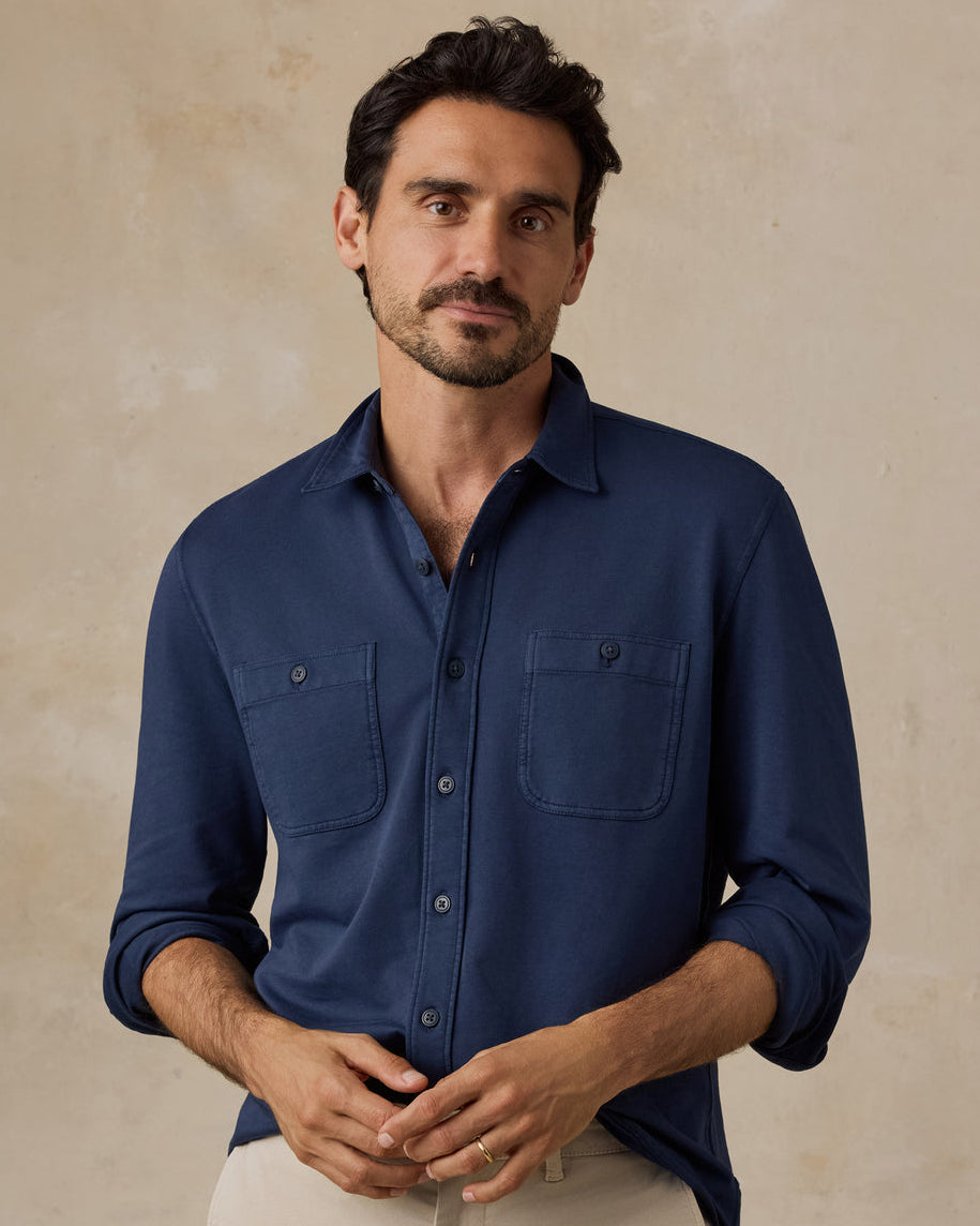 Man wearing a navy blue button-up shirt with two chest pockets