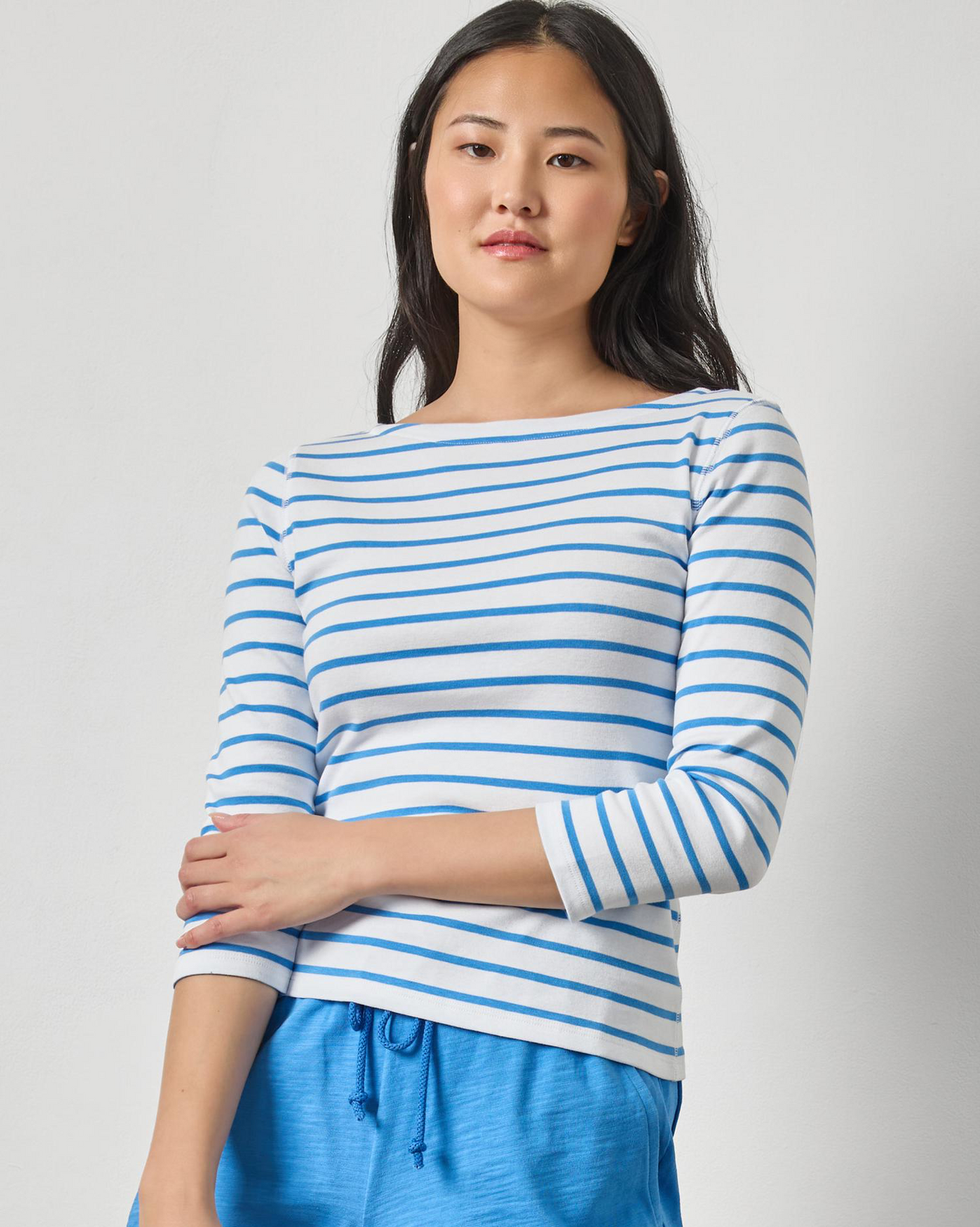 Rib Stripe 3/4 Boatneck with blue stripes in yarn-dyed rib fabric styled with casual blue shorts