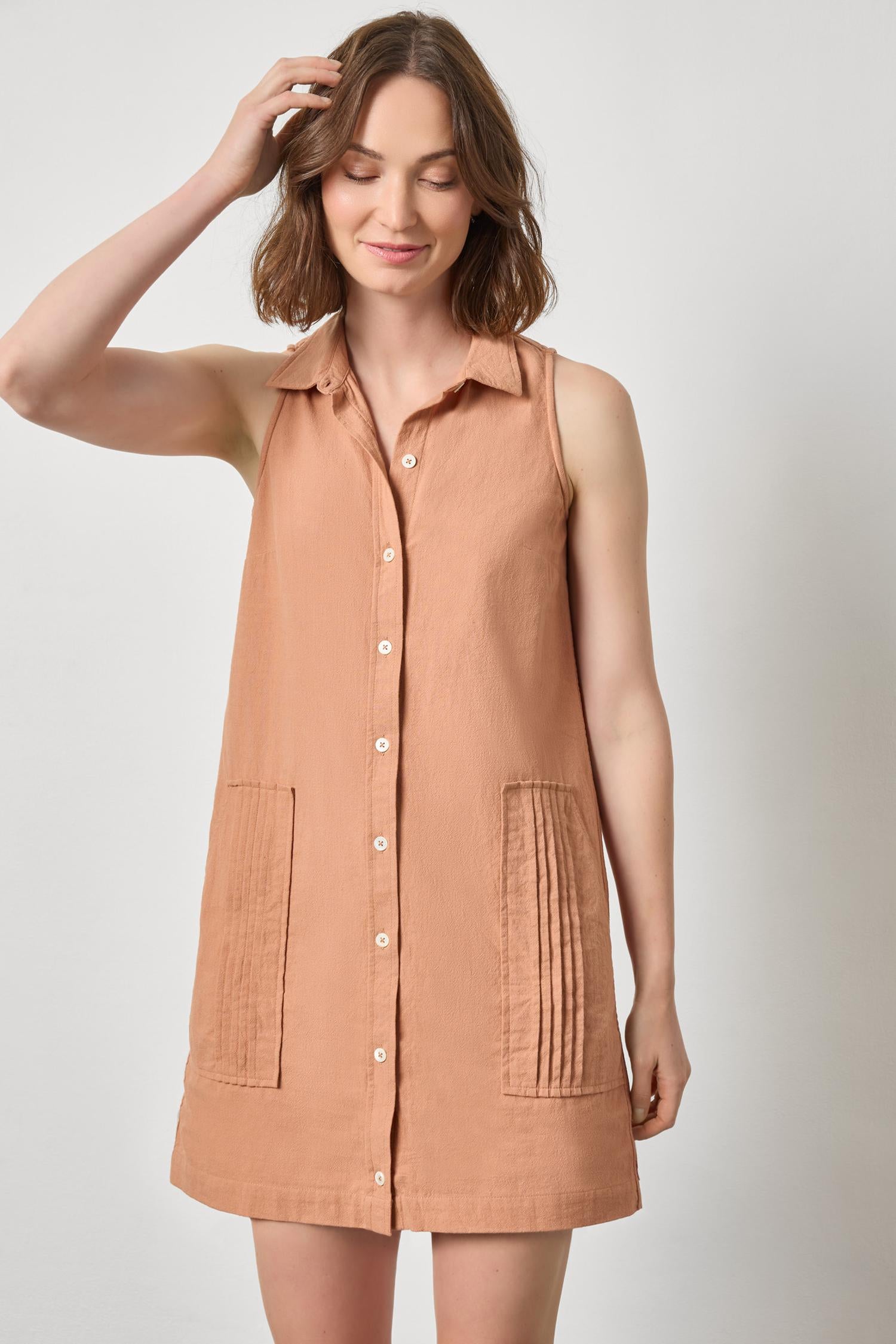 Sleeveless Pleat Pocket Dress in beige textured cotton, styled with relaxed, effortless charm
