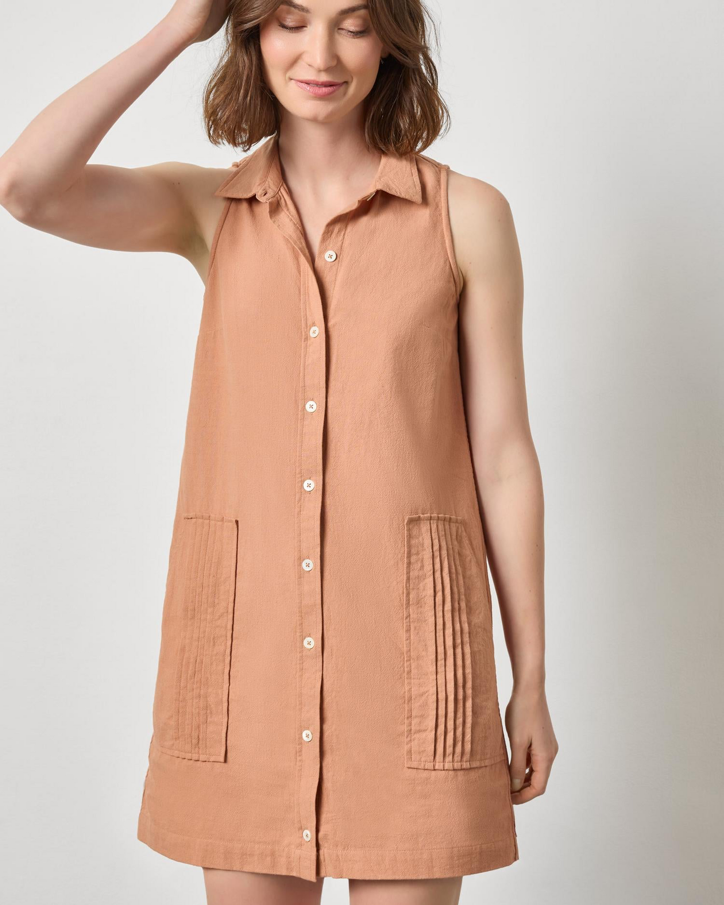Sleeveless Pleat Pocket Dress in warm terracotta textured cotton by LILLA P, styled simply