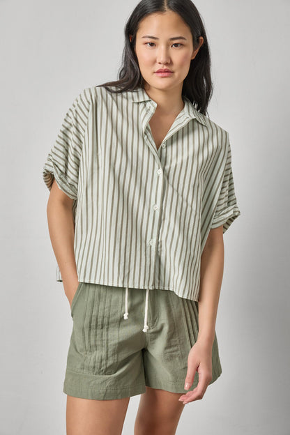Model wearing Striped Oversized Button Down Dolman in cotton poplin, styled with casual green shorts