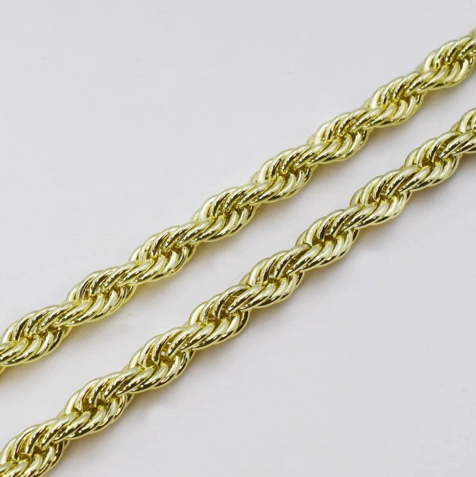 Close-up of chunky gold rope chain necklace links with braided twisted texture