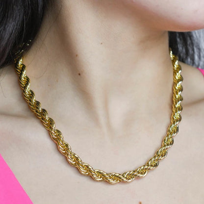 Gold rope chain necklace on the neckline with twisted, chunky links