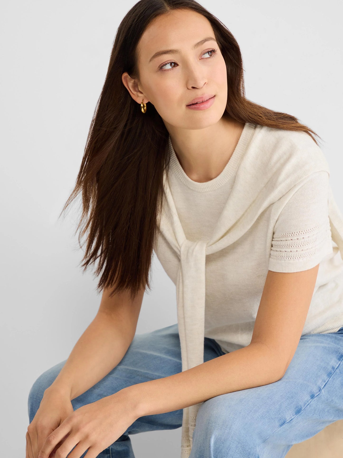 Piazza Over The Shoulder Sweater in beige and white knit styled casually with light blue jeans