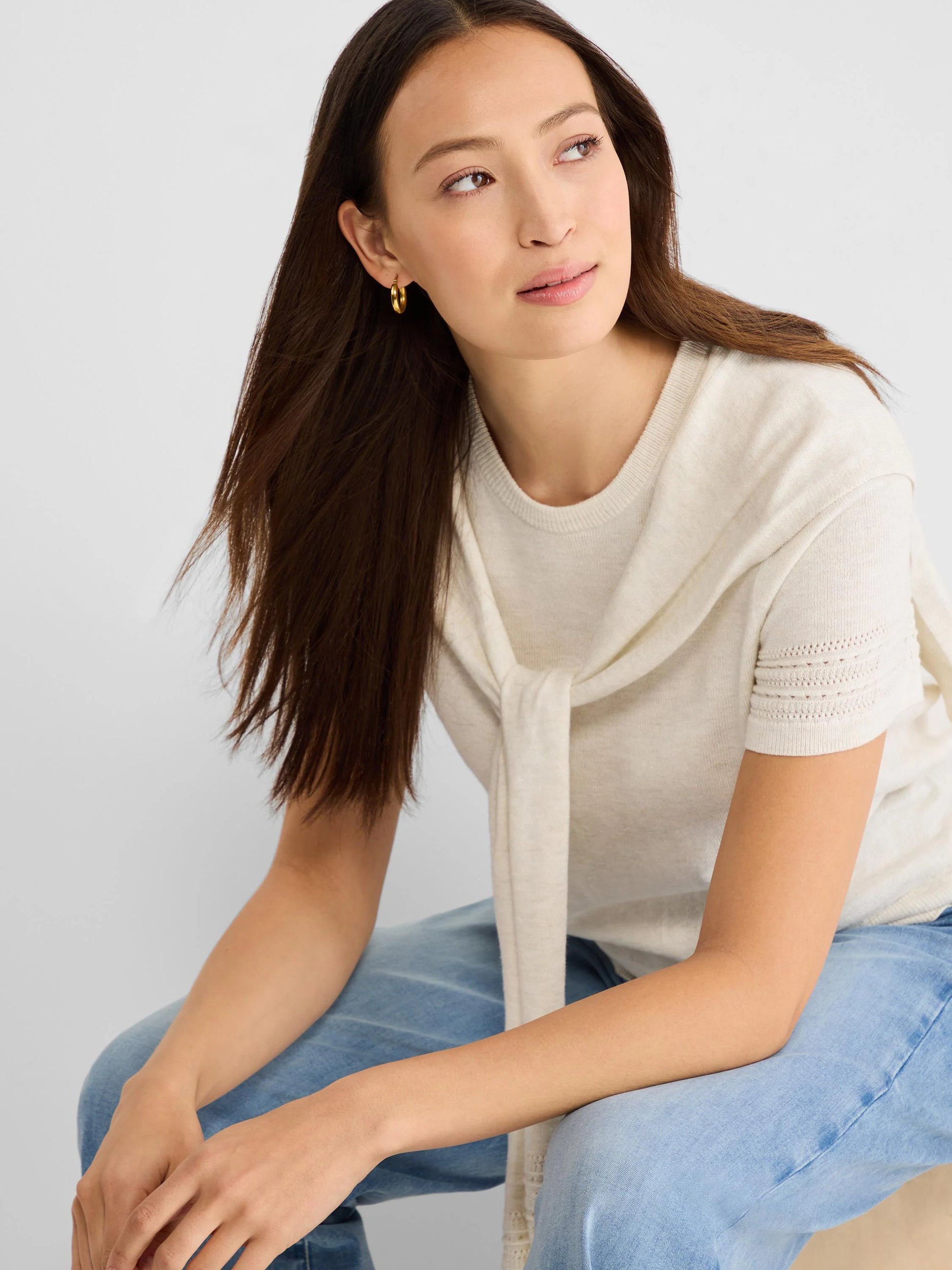 Piazza Over The Shoulder Sweater in beige and white knit styled casually with light blue jeans