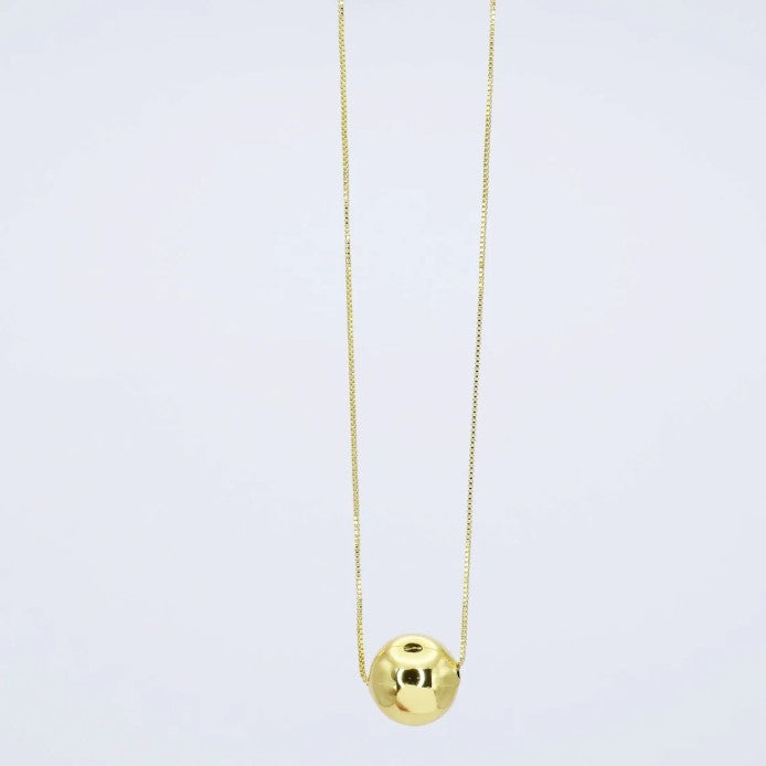 Gold chain necklace with round glossy pendant and center eye detail