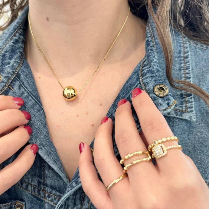 Gold Fireball necklace with round eye pendant on a delicate chain