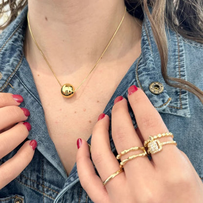 Gold Fireball necklace with round eye pendant on a delicate chain