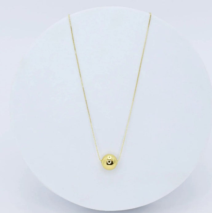 Fireball necklace with gold chain and round eye pendant