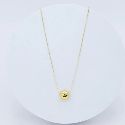 Fireball necklace with gold chain and round eye pendant