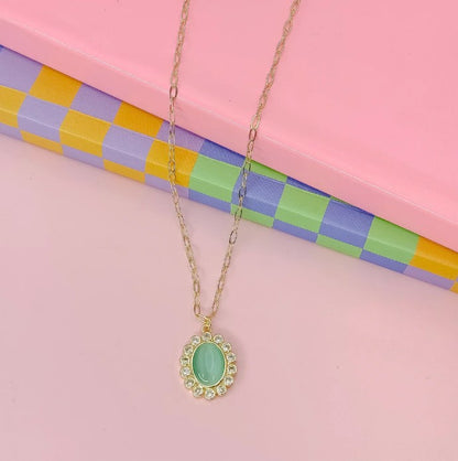 Vintage Grace Necklace in gold with green oval pendant and small rhinestone frame