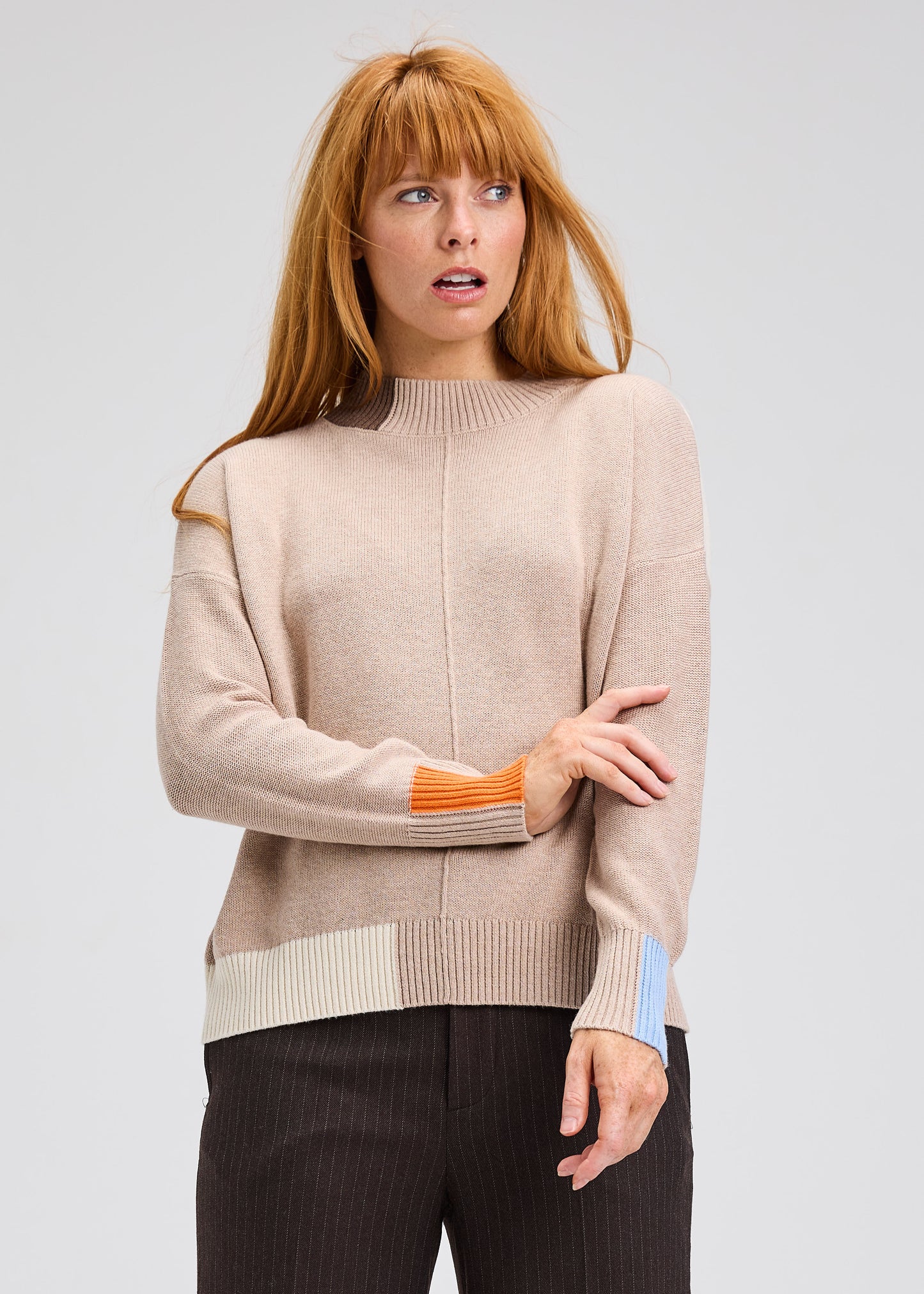 Oat color block trim sweater, ribbed crew neck and striped cuffs with orange accents