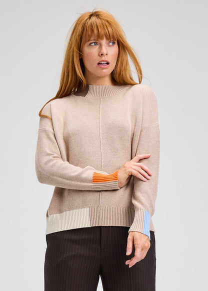 Oat color block trim sweater, ribbed crew neck and striped cuffs with orange accents