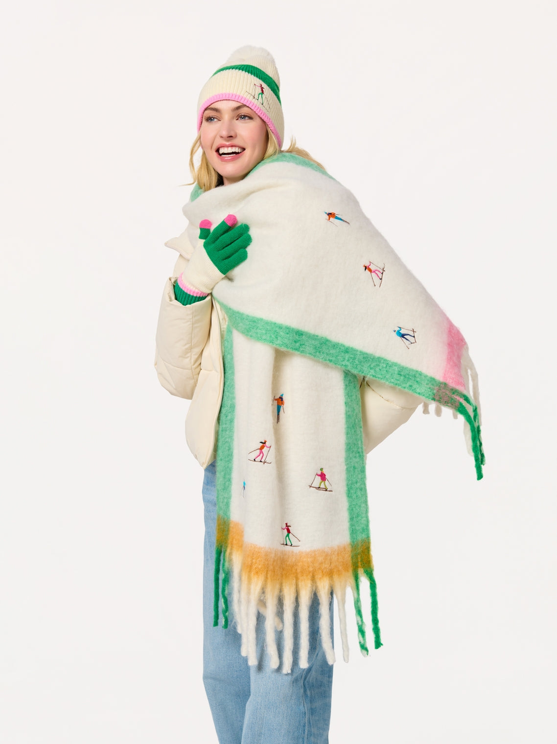 Woman wearing Alpine Scarf with whimsical skier embroidery, styled with knit accessories