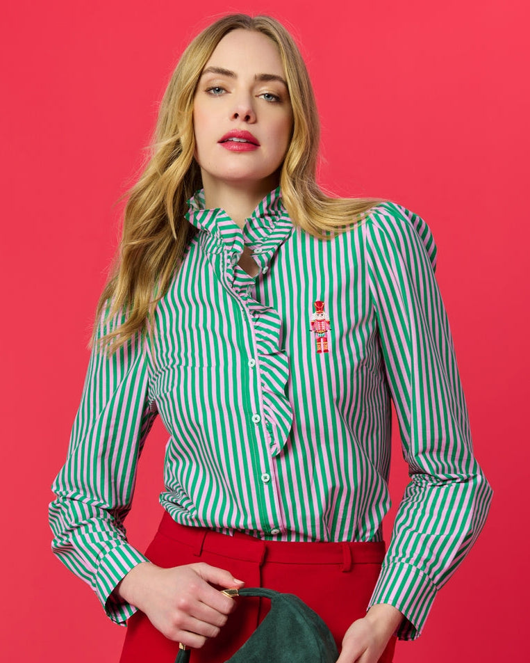 Woman wearing Nutcracker Ruffle Blouse with green and pink stripes at HCO Fredericksburg