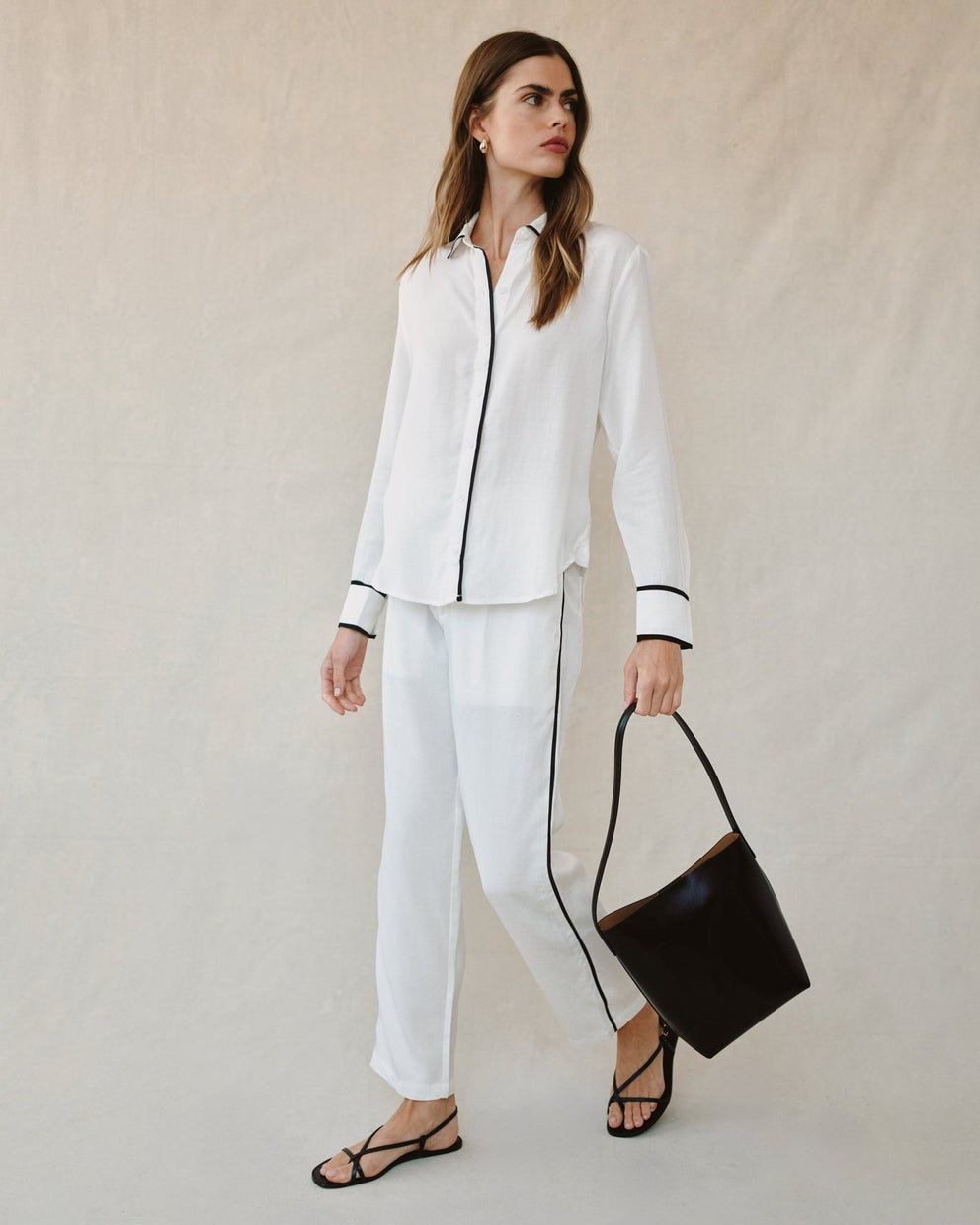 Off-white shirt with contrast black cuffs and vertical button-front trim
