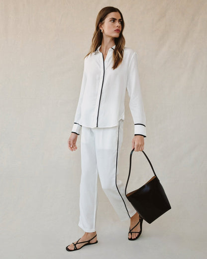 Off-white shirt with contrast black cuffs and vertical button-front trim
