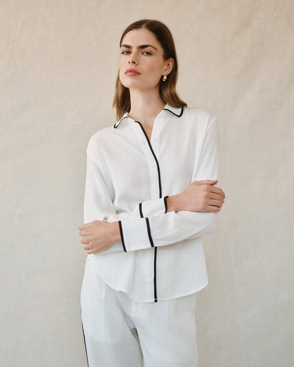 Off-white button-up shirt with contrast black collar and side-slit hem