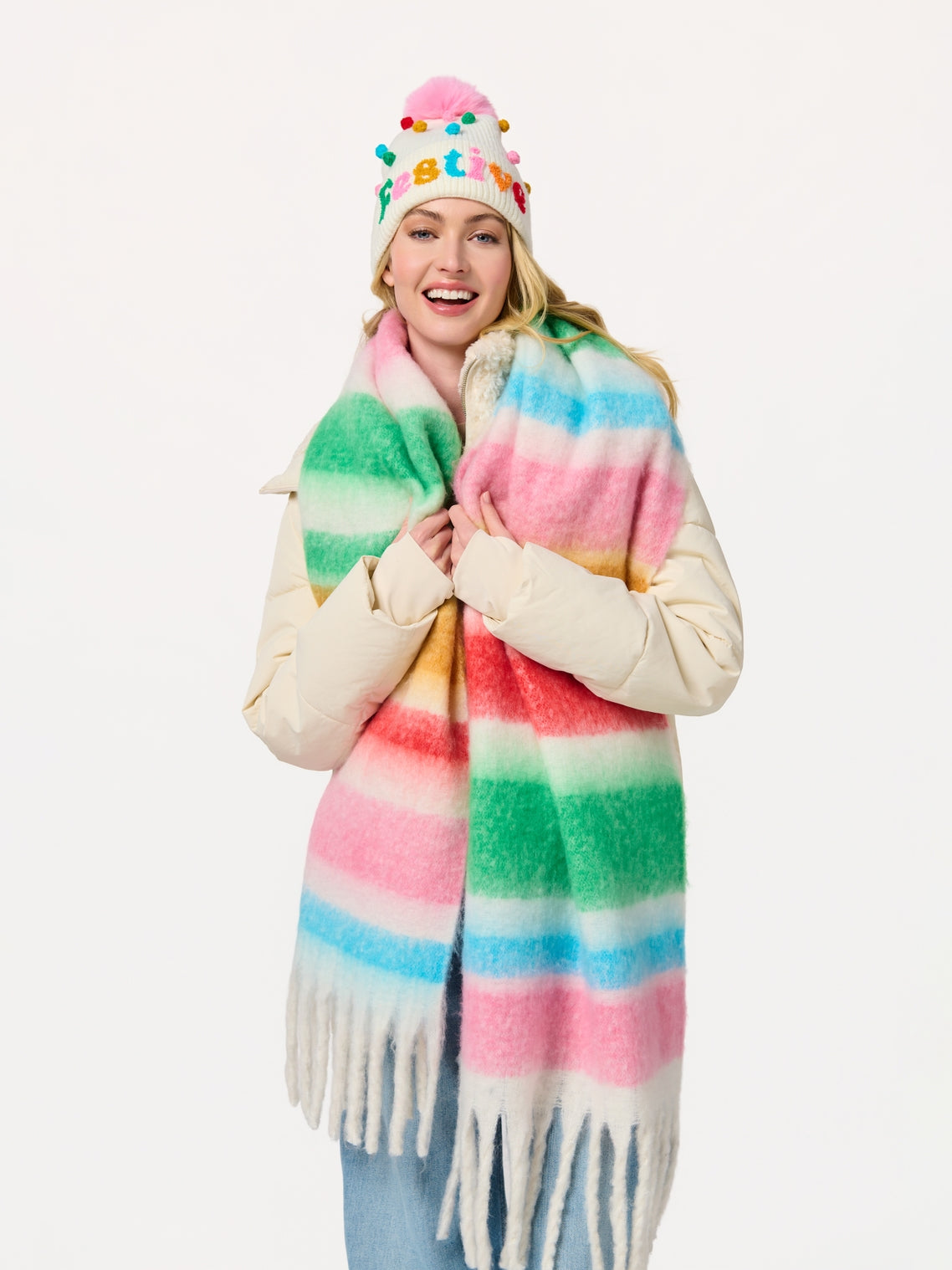 Lala Scarf with soft pastel tie-dye stripes and fringe styled with festive pom-pom hat