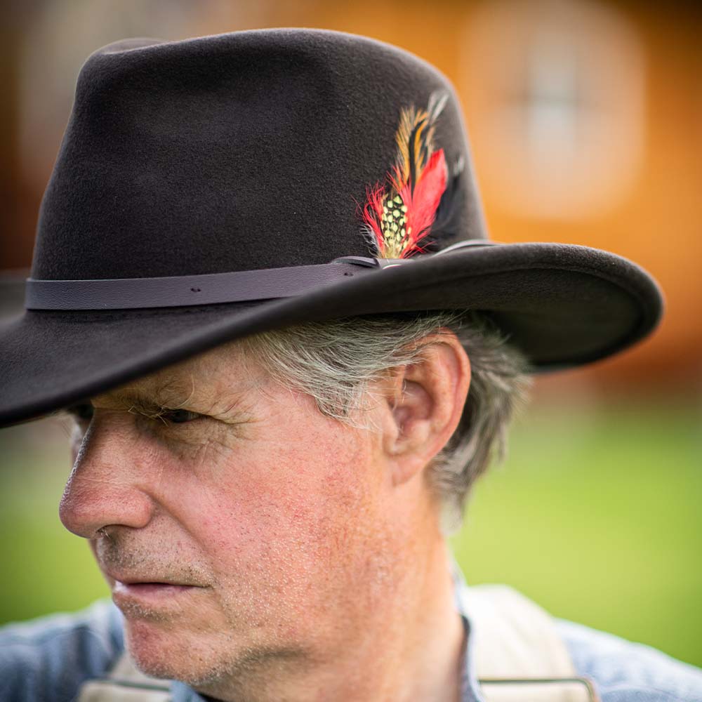 Crushable Felt Outback black wool felt hat with leather band and multicolor feather accent