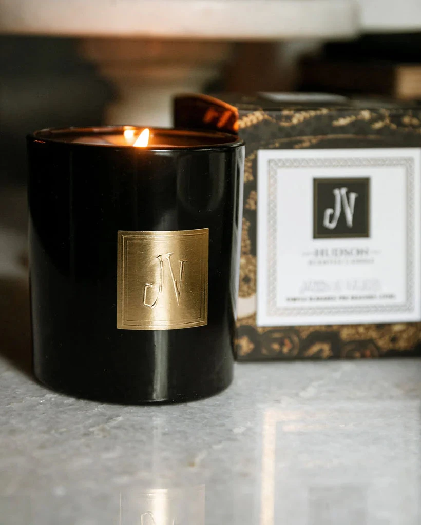 Hudson Candle in black glass with gold emblem, lit by JACKSON VAUGHN, Candles HCO collection
