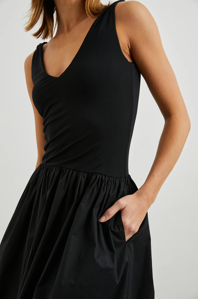 Close-up: black sleeveless V-neck bodice with gathered waist skirt