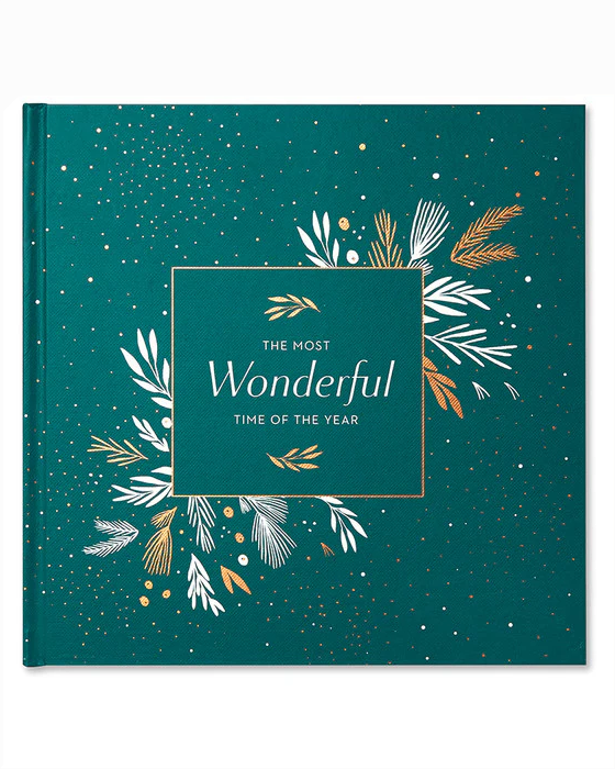 The Most Wonderful Time Of The Year book with elegant green cover featuring gold and white botanical illustrations and festive accents, personally curated in Fredericksburg, Texas.