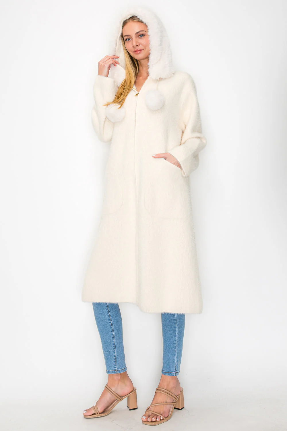 Suraya Knitted Brushed Coat in beige, white, with faux fur hood and pom-poms by JOH APPAREL