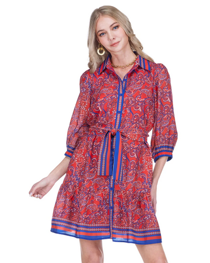 Woman wearing a red and blue patterned dress on a white background