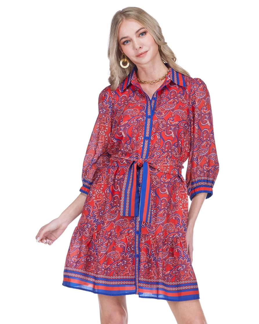 Woman wearing a red and blue patterned dress on a white background