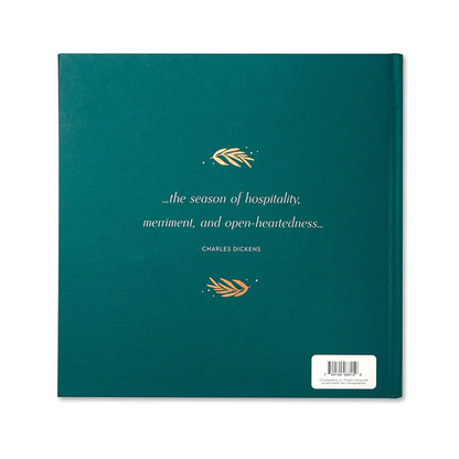The Most Wonderful Time Of The Year book with a deep green cover featuring a Charles Dickens quote about hospitality and merriment, accented with gold foil details.