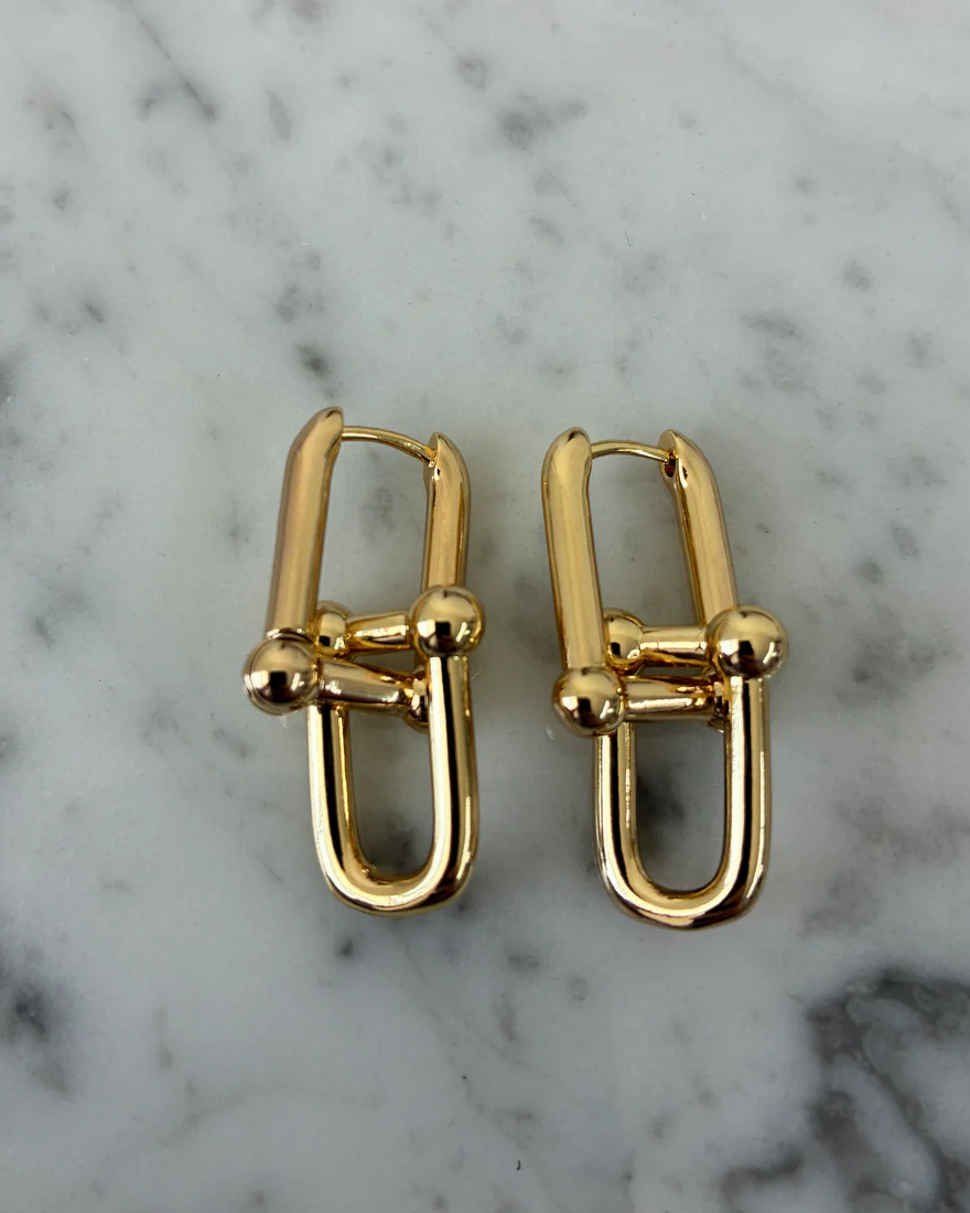 Pair of gold dangle earrings: U-shaped hoops with cross bar and round balls