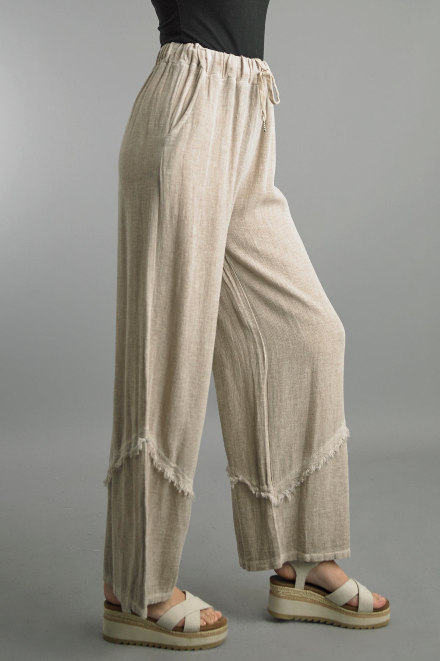 Palazzo Pants in beige wash linen with relaxed wide-leg fit and frayed hem from TEMPO PARIS