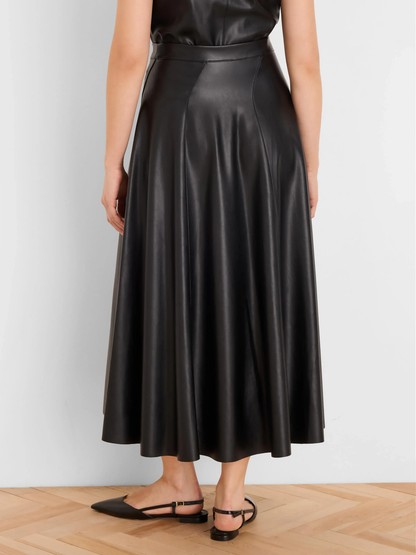 Woman wearing a black leather midi skirt and strappy flat sandals