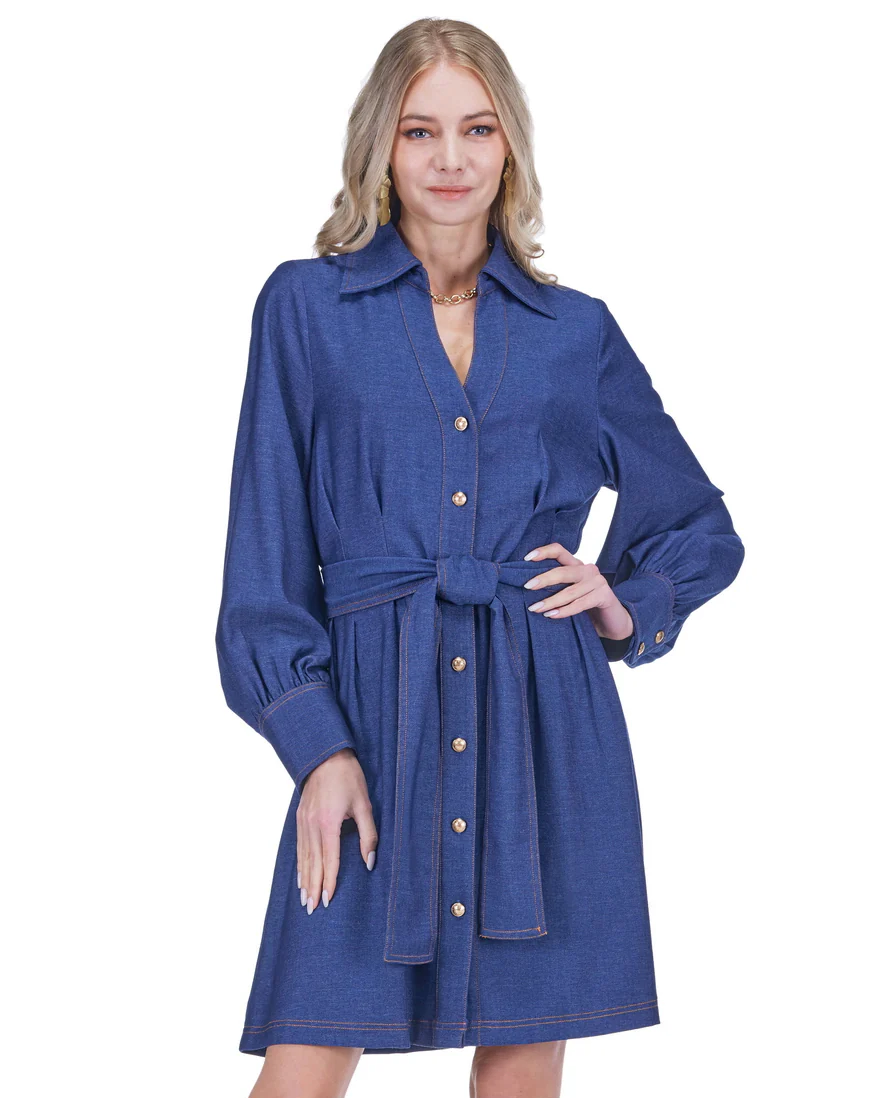 Woman wearing a blue dress with a belt on a white background