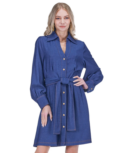 Woman wearing a blue dress with a belt on a white background