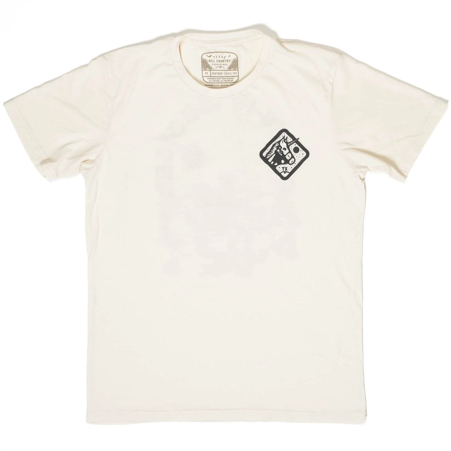 Cream-colored short-sleeve cotton tee with a small black graphic emblem on the chest, featuring the "Texas Is Magical Tee" in a casual, comfortable style.