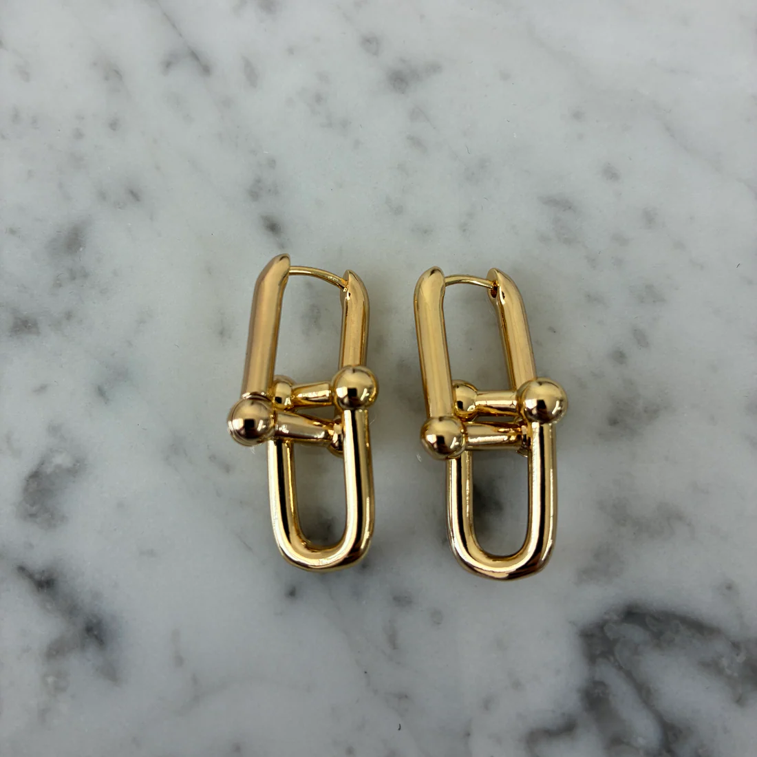 Gold U-link dangle earrings with square links and round bead accents