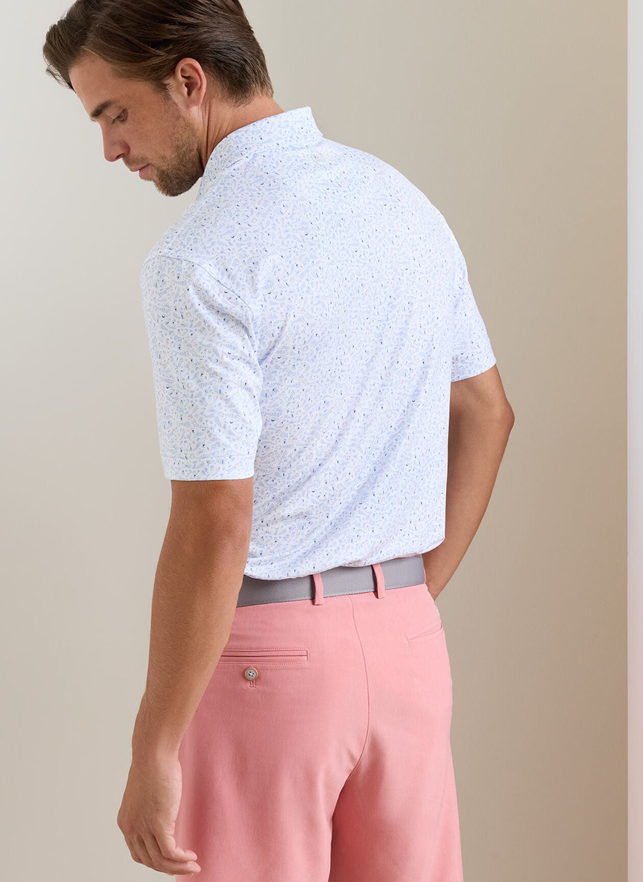 Nice Shot Performance Jersey Polo with multicolor floral blue and white pattern, moisture wicking
