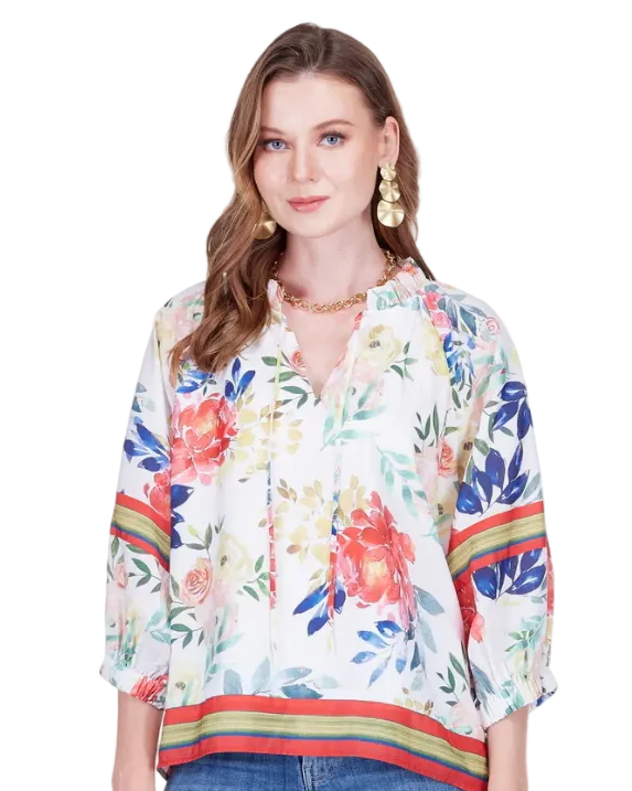 Woman wearing a colorful floral blouse with a white background