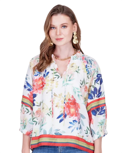 Woman wearing a colorful floral blouse with a white background