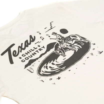 Close-up on Water'N Hole Tee print: Texas Chill Country cowboy in splash pool