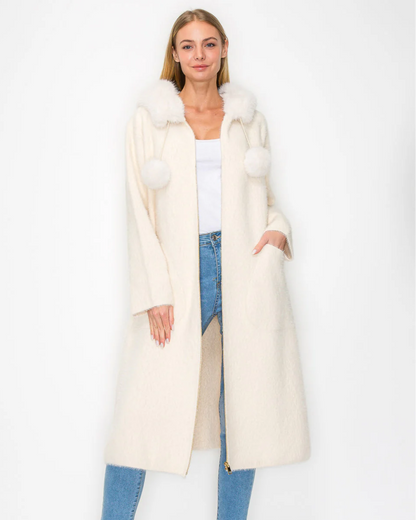 Suraya Knitted Brushed Coat in beige and white with faux fur hood and pom-poms by JOH APPAREL