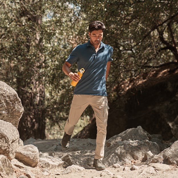Vacationer Polo in blue breathable men's shirt by ROYAL ROBBINS, styled for outdoor adventure