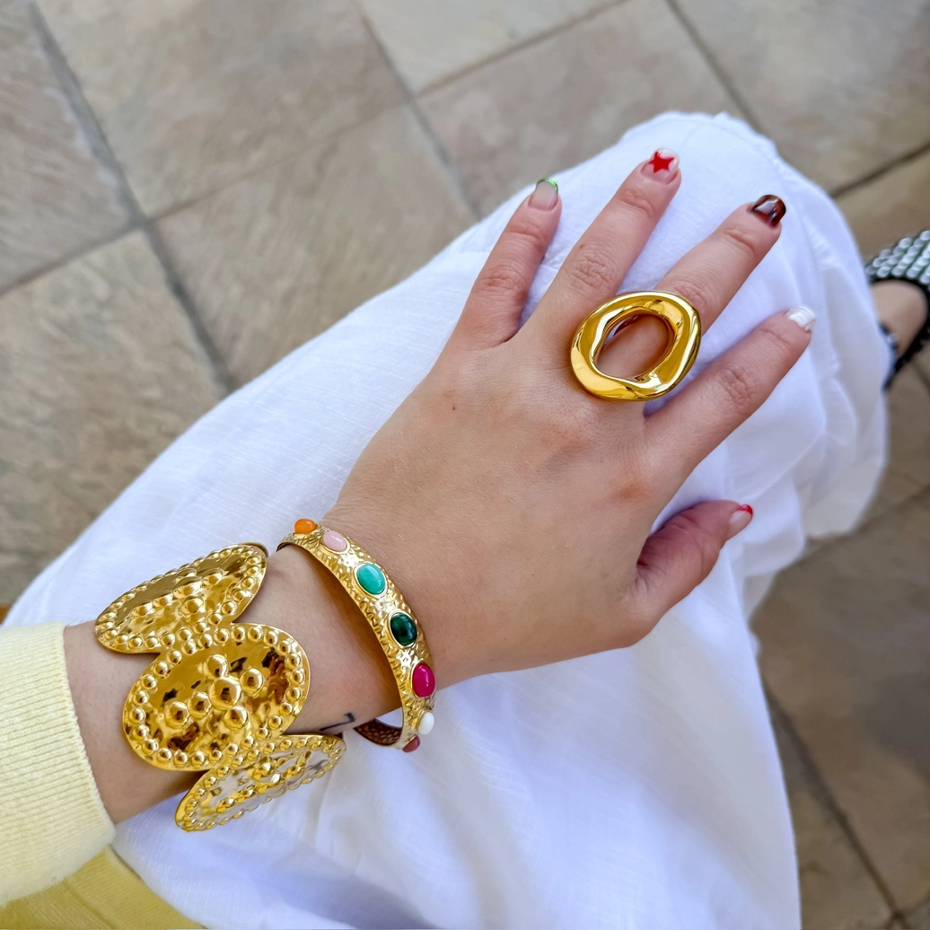Paraiso Bangle hammered gold cuff with colorful oval stones from Treasure Jewels collection