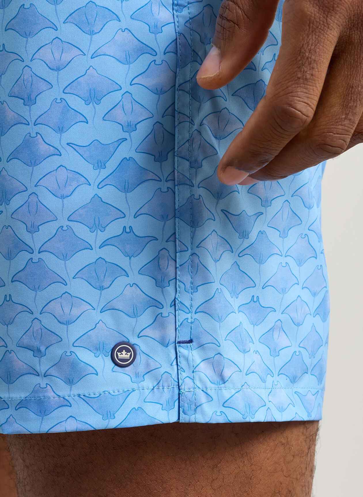 Coronado Swim Trunk close-up of blue animal and geometric quick-dry stretch fabric pattern