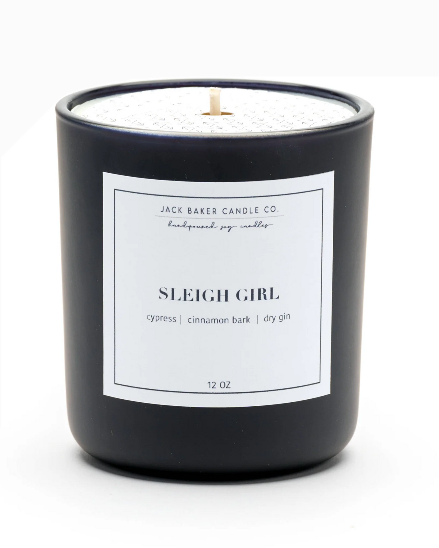 Black candle with a white label on a white background