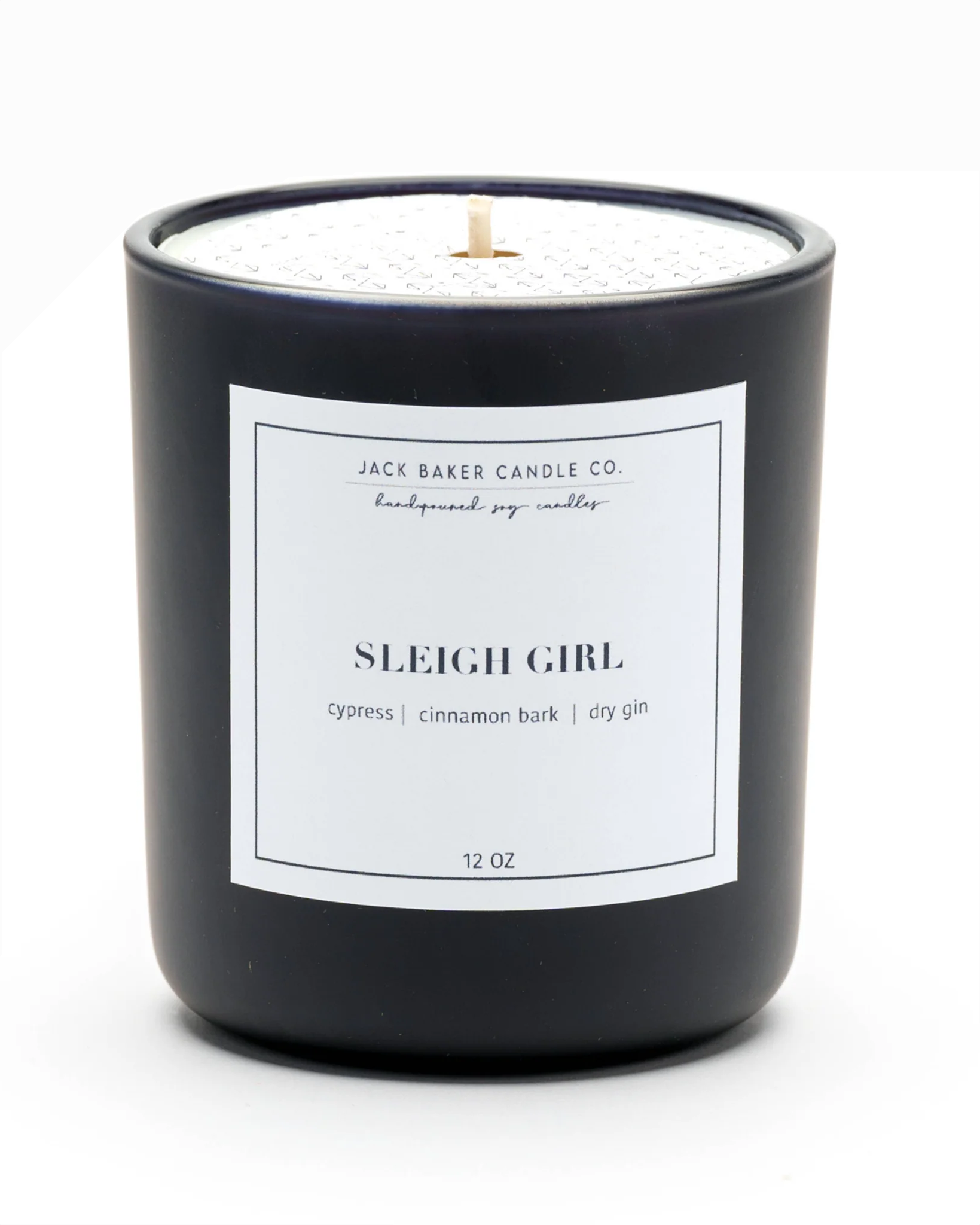 Black candle with a white label on a white background